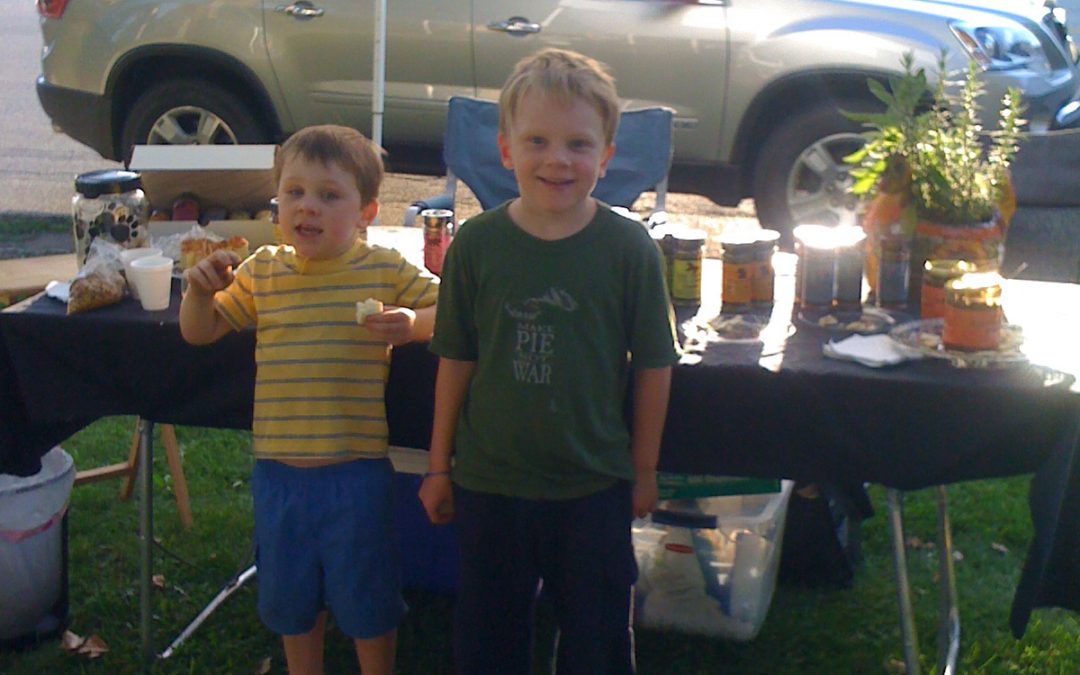 Two boys standing at vendor table