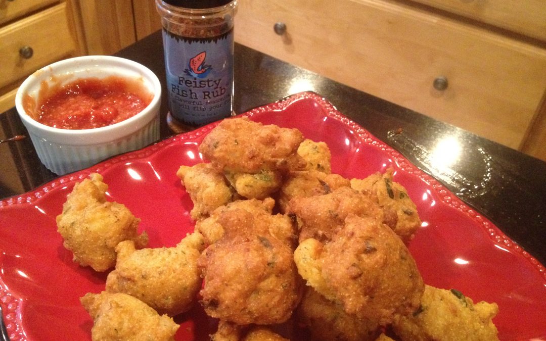 Corn fritters on red plate with sauce