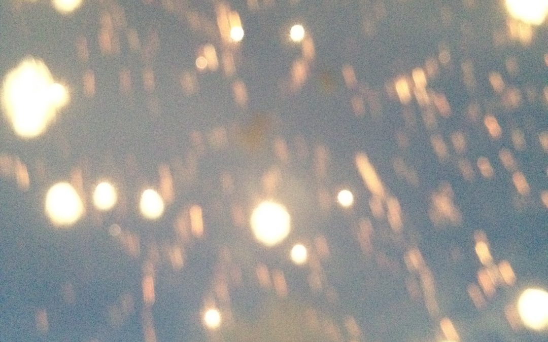 Blurry golden sparks in dusk sky