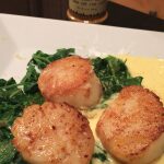 Seared scallops on spinach with creamy sauce