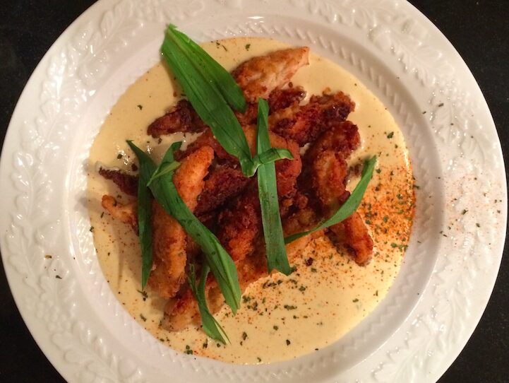Crispy fried chicken strips with creamy herb sauce