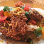 Crispy fried chicken taco with tomatoes and cheese