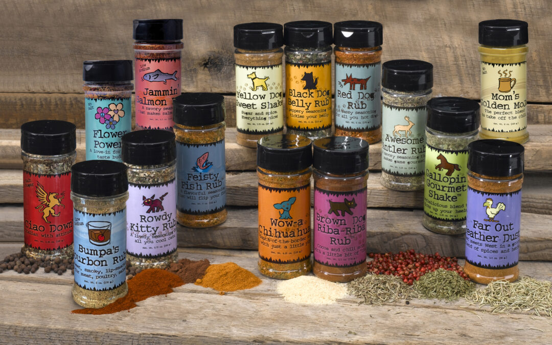 Assorted spice rub jars on wooden table