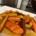 Glazed rainbow carrots on white plate