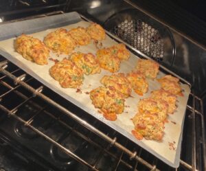 Cheesy vegetable drop biscuits baking on tray